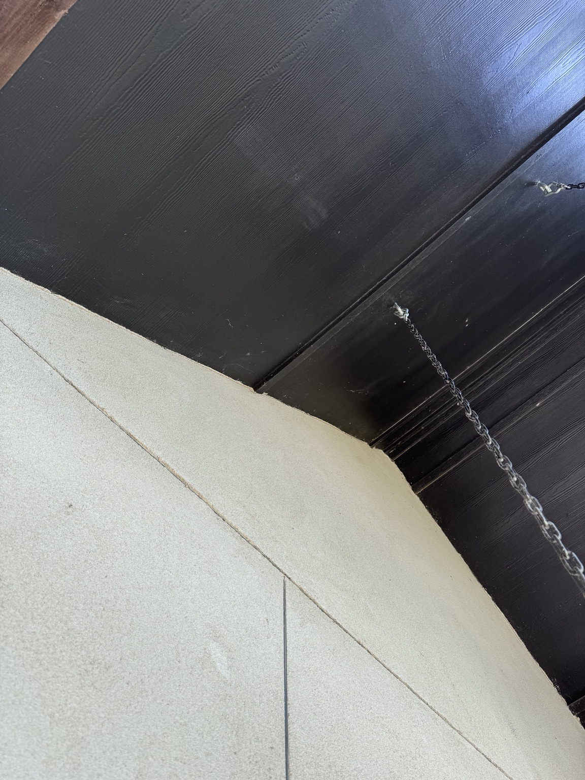 Covered exterior soffit corner after cobweb removal