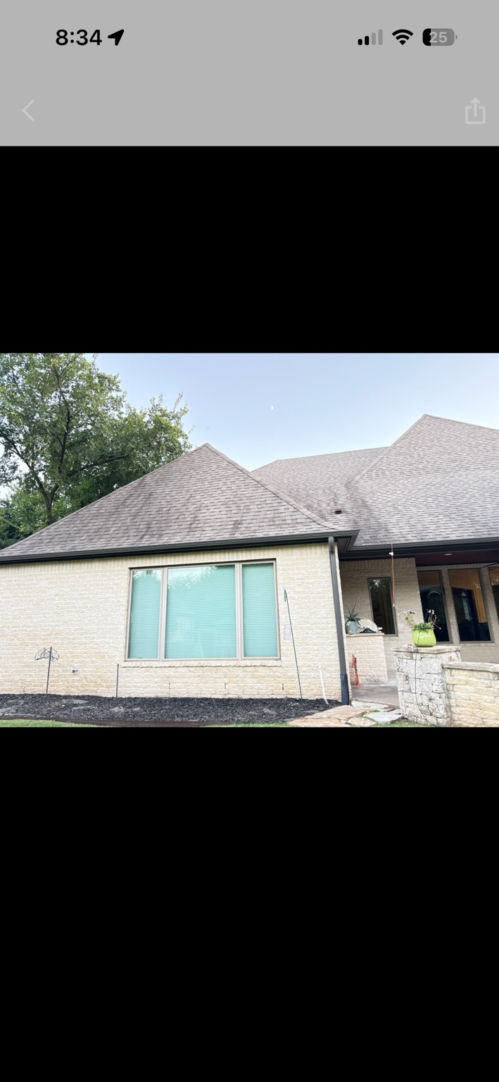 Dark organic streaks visible across a residential shingle roof