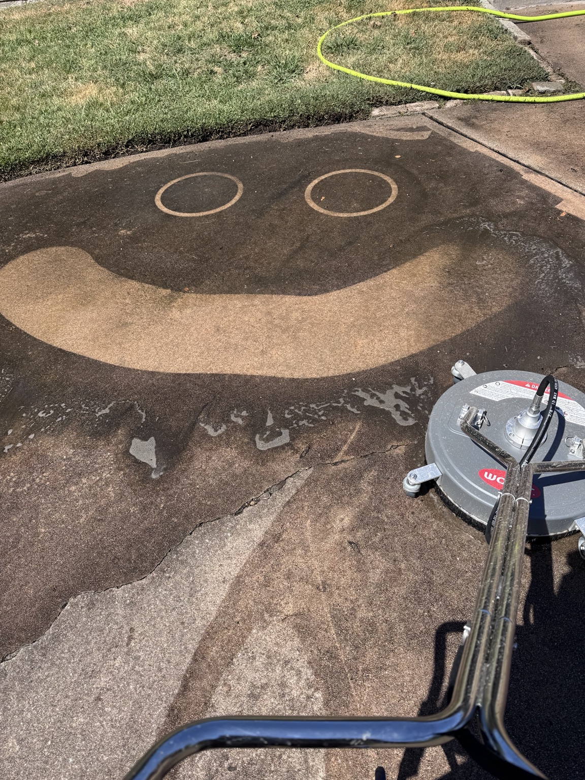 Smiley face cleaned into concrete