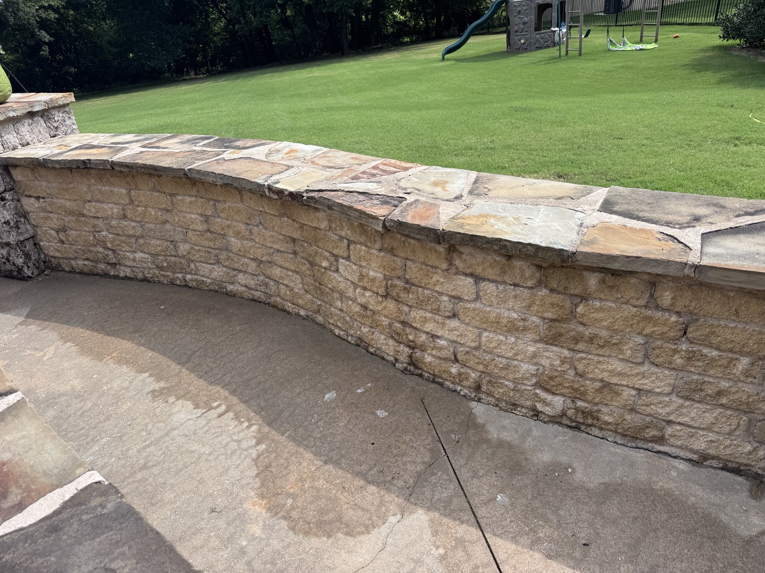 Stone patio wall after exterior cleaning